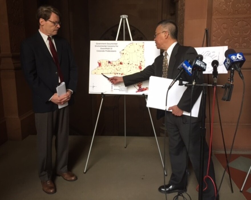 NYPIRG's Blair Horner and Toxic Targeting's Walter Hang present documents on unfinished oil spill clean ups in New York.