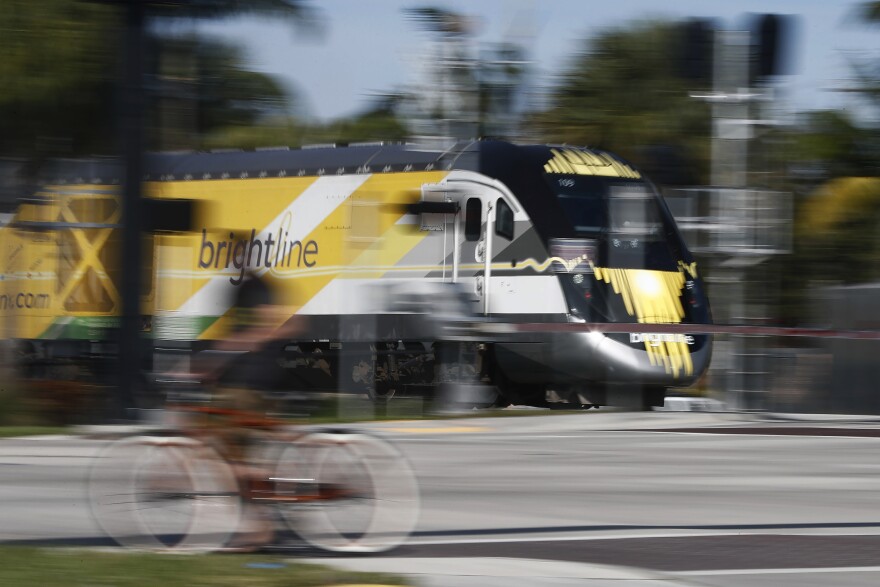 A white and yellow train on a track