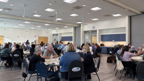 Groups of Columbia residents sit around circular tables at a meeting of the Steering Committee on Homelessness on August 27, 2026.