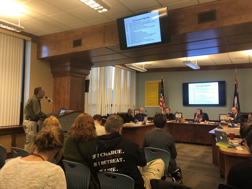 ill Tallen, a supporter of the policy, speaks to the board before the final vote.