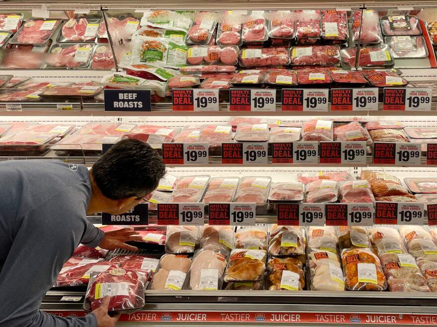 A man shops for meat at a grocery store in Annapolis, Md., on May 16 as Americans brace for summer sticker shock because of high inflation.