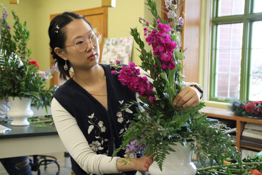 Sophie Ahrens, one of the Unexpected Bloom's scholarship recipients, works on an arrangement in her floral design program at Johnson County Community College.