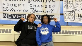 Rev. Denise O. Walden-Glenn and Alia Williams each raise a fist— a symbol of solidarity and Black power— at the VOICE office in Buffalo, New York.