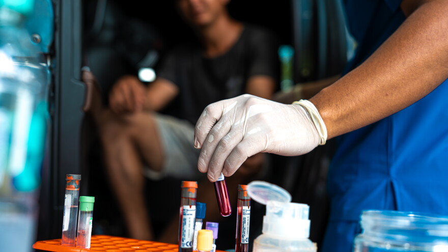 A nurse holds a blood sample taken from a participant as part of the CURE study in Usulutan, El Salvador.