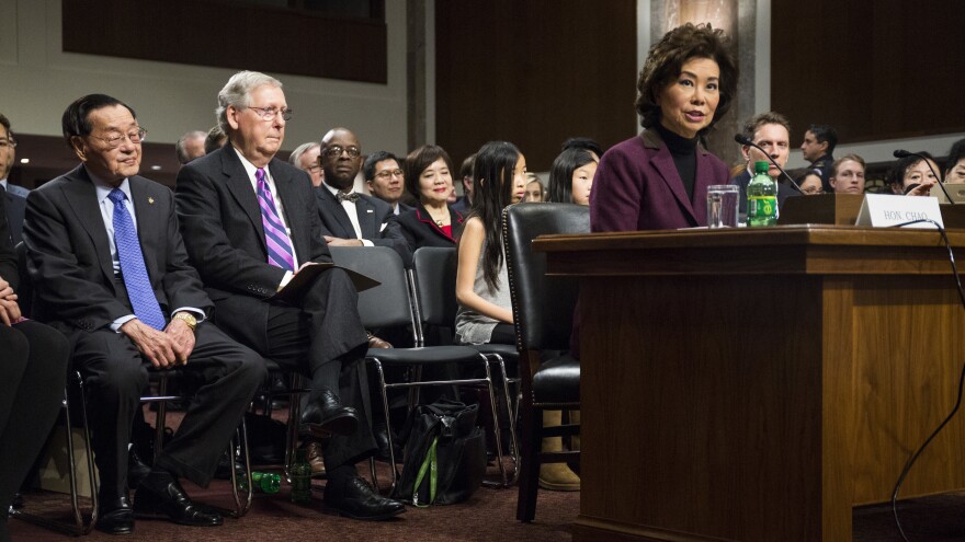 Secretary of Transportation-designate Elaine Chao testifies at her confirmation hearing before the Senate Commerce, Science and Transportation Committee. Listening are her father, James Chao, left, and husband, Senate Majority Leader Mitch McConnell.