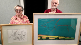 Nancy and Fred Jones at the TSPR studios. Nancy is holding one of her works, “Growth,” and Fred is displaying his piece “Lightning Hits Old Mississippi."
