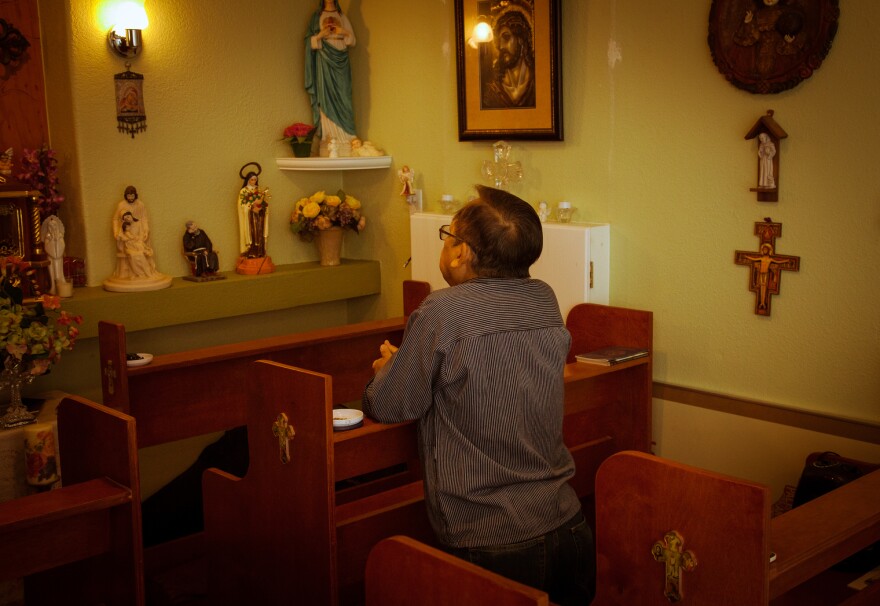 Guerra says a prayer in the chapel he constructed in his garage. He has never returned to the Philippines since coming to America in the 1980s. "My parents are already dead. My only brother is dead. So there's no more thing for me to go to the Philippines," he said.