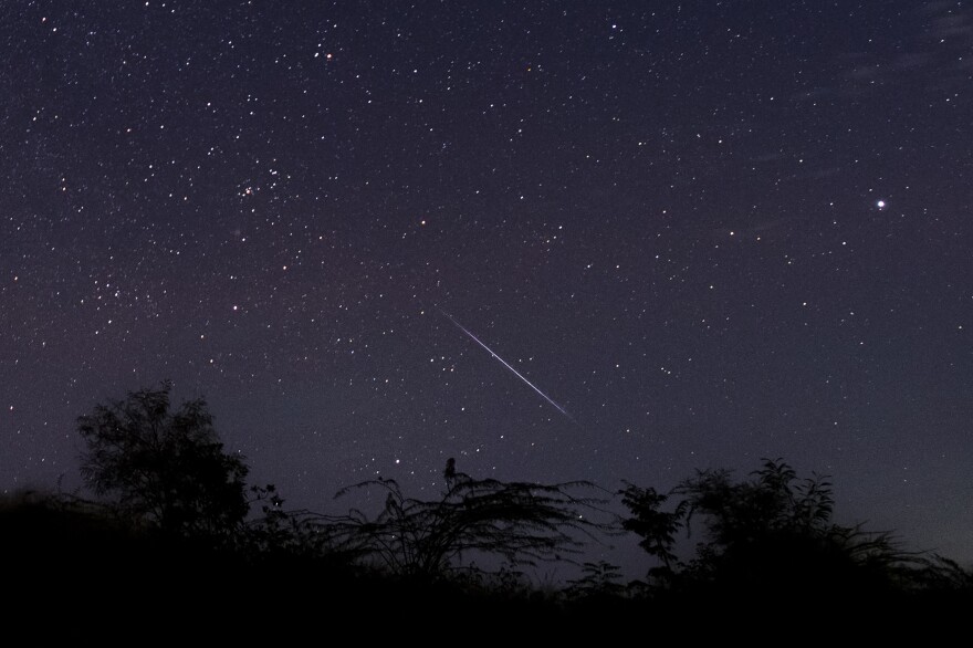TOPSHOT - This photo taken late December 14, 2018 with a long time exposure shows a meteor streaking through the night sky over Myanmar during the Geminid meteor shower seen from Wundwin township near Mandalay city. (Photo by Ye Aung THU / AFP) (Photo by YE AUNG THU/AFP via Getty Images)