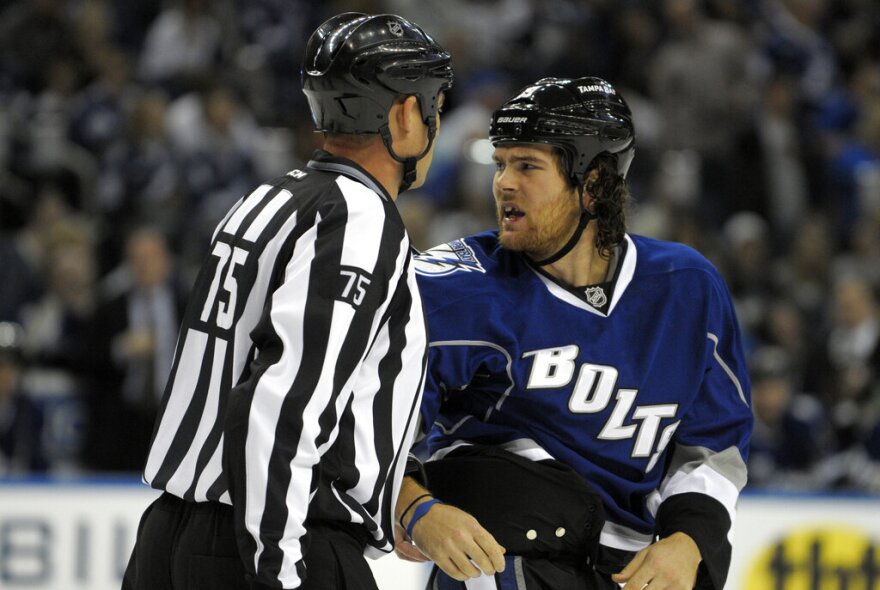 Tampa Bay Lightning's Steve Downie, right, is escorted away from a fight during the first period of an NHL hockey game against the Buffalo Sabres in Tampa, Fla., Saturday, Oct. 22, 2011.(AP Photo/Phelan M. Ebenhack)