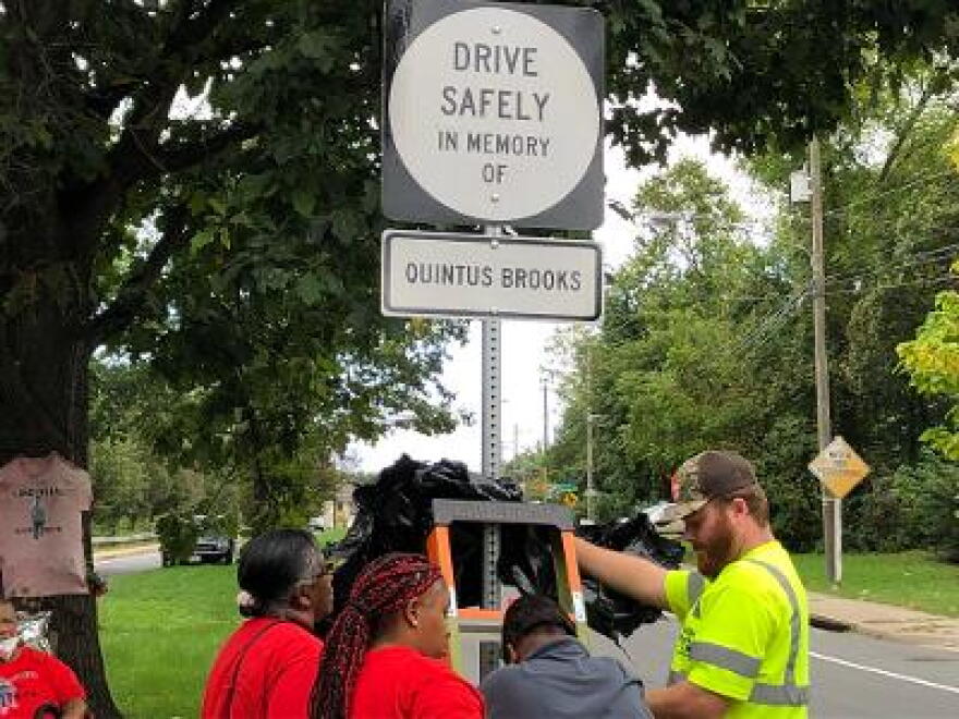 The family of Quentus Brooks helps install the city's first official roadside memorial.