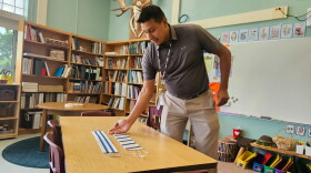 Tuscarora Elementary School teacher Aaron Printup uses a replica wampum belt to describe the relationship of the six nations in the Haudenosaunee Confederacy.