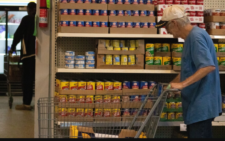 Visitors of God's Food Bank in Guthrie push their carts in the self-serve pantry.