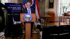 Gov. Mike DeWine with his dog, Dolly, at a coronavirus briefing in September 2020.