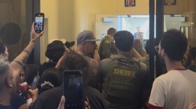 Residents crowd the hallway outside Coachella City Hall during a Wednesday, May 27, 2026 council meeting as tensions flare over a proposed tech campus that would build six data centers on 450 acres.