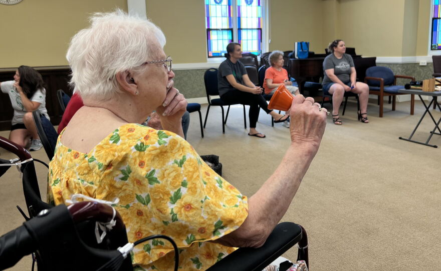 A memory cafe participant rings her handbell during the music session.