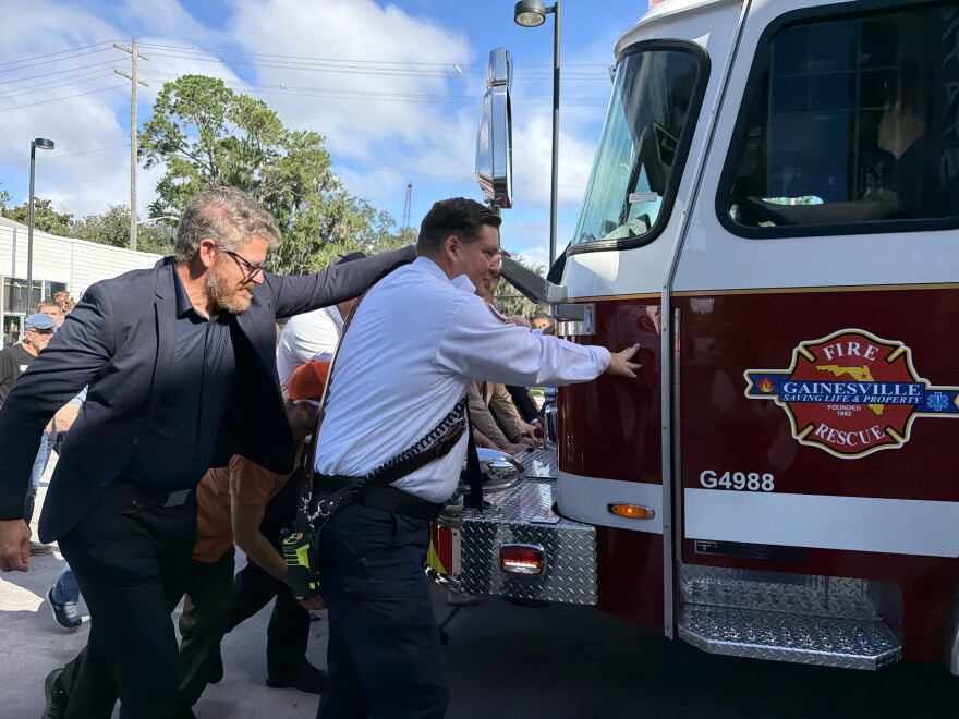 Gainesville Fire Rescue firefighters and area residents push the department’s new Engine 1 into Station 1 on Thursday, Sept. 24, 2026. (Genesis Trujillo/WUFT News)