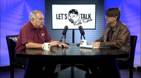 Keith Spera sits across from Cajun accordionist and songwriter - Bruce Daigrepont at the Let's Talk table
