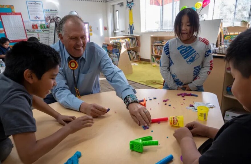 Principal Dan Porter and first-grade students at Kwiyagat Community Academy enjoy some free time as the school day closes.