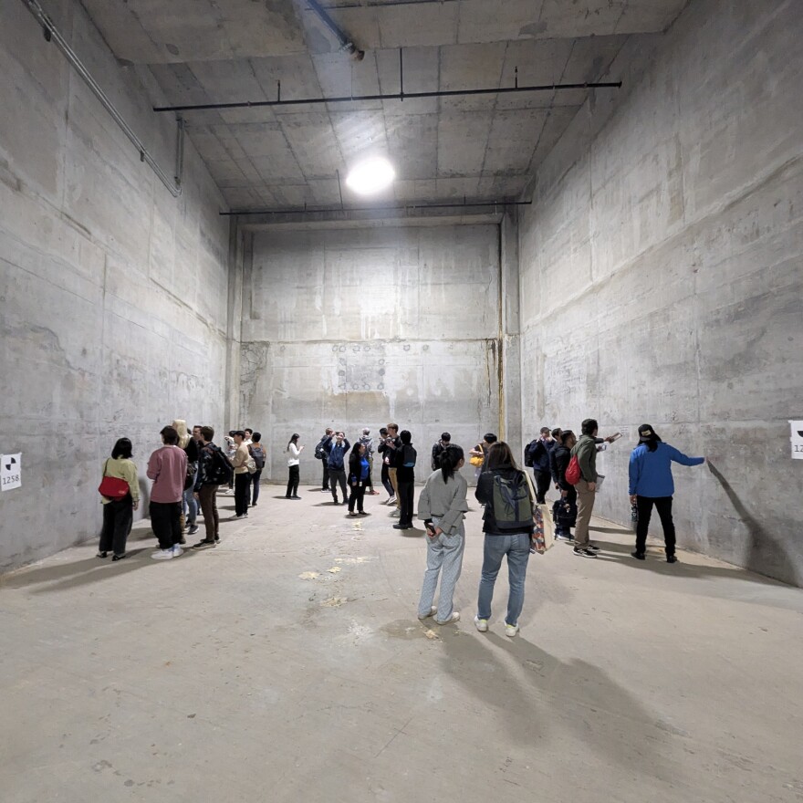 Graduate students from UC Berkeley examine a knockout wall inside the Train Box. This wall will eventually be removed when excavation and construction begins on a new connecting rail tunnel to 4th and Townsend Streets in San Francisco.