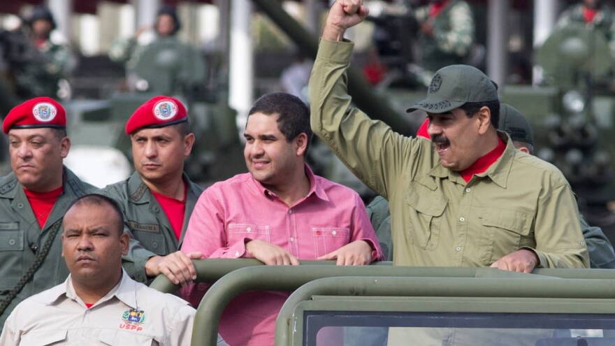 Venezuelan President Nicolas Maduro raises a fist during a military parade in Caracas this year.