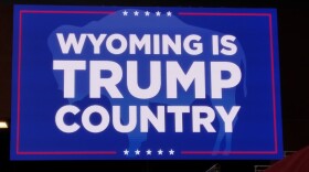 A red, white, and blue campaign sign reads "Wyoming is Trump country"