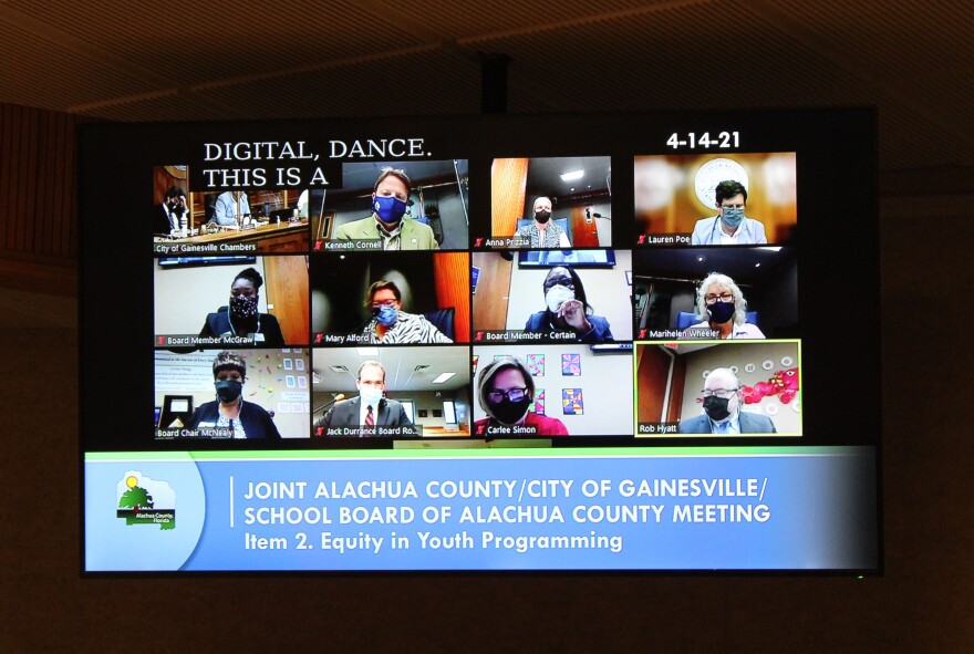 From top left: City of Gainesville Chambers, Commissioner Ken Cornell, Commissioner Anna Prizzia, Mayor Lauren Poe, Board Member McGraw, Commissioner Mary Alford, Board Member Certain, Commissioner Marihelen Wheeler, Board Chair McNealy, Colin Murphy, Superintendent Carlee Simon and Board Member Rob Hyatt on a zoom conference for the joint meeting discussing equity in youth programming. (Briana Farrell/WUFT News)