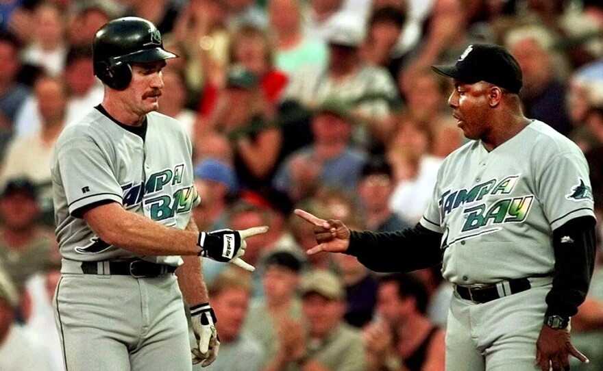 Tampa Bay Devil Rays' Wade Boggs, left, gets congratulations from first base coach Billy Hatcher after Boggs sluggged a second-inning single against the Seattle Mariners Wednesday, Aug. 4, 1999 in Seattle. The hit was the 2,997th of his career.