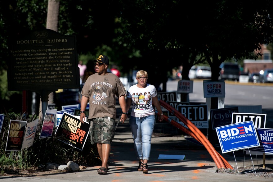 People walk down the sidewalk outside of Jim Clyburn's World-Famous Fish Fry. Unlike Iowa, New Hampshire, and Nevada, in South Carolina's Democratic primary, a majority of votes will be cast by African Americans.