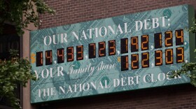 The National Debt Clock, a billboard-size digital display showing the increasing U.S. debt, is seen in New York City on Monday. Congress passed a bill Tuesday that would raise the nation's debt limit.
