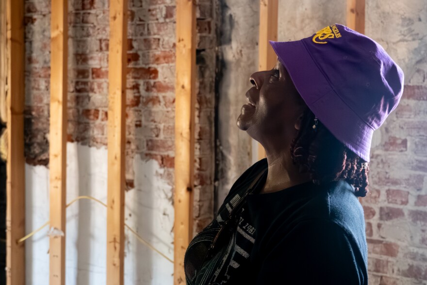 Emma Stroud assesses damage in her family’s tornado damaged north St. Louis home on Wednesday, Sept. 10, 2025.