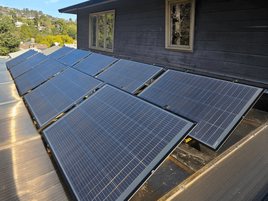 A set of plug-in solar panels are pictured on a rooftop. Portable solar panels come in a range of sizes and can be plugged into a wall outlet, something that legislators said makes them accessible to renters but requires additional safety considerations
