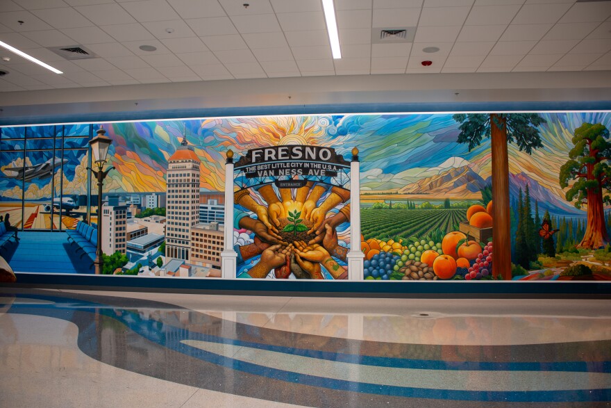 The floor-to-ceiling mural, titled “Fresno Airport: A Welcoming Adventure,” was painted by two local artists.
