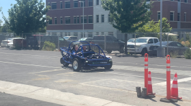 High school students driving the vehicle they built at ASPIRE Summer EV Academy