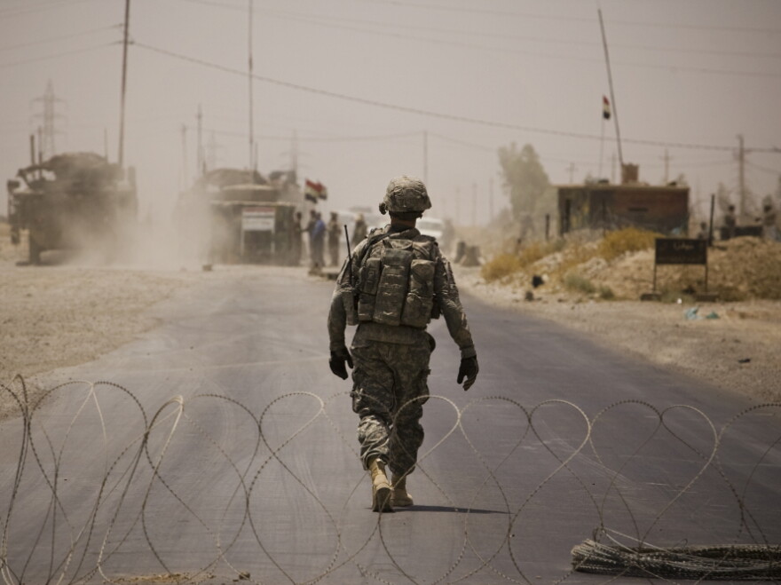 The release of hundreds of thousands of "action reports" by the WikiLeaks website offers a new level of detail about the U.S. occupation of Iraq. Here, a U.S. soldier walks through a checkpoint set up after a car bomb attack killed two U.S. soldiers in  Diyala Province, June 11, 2010.