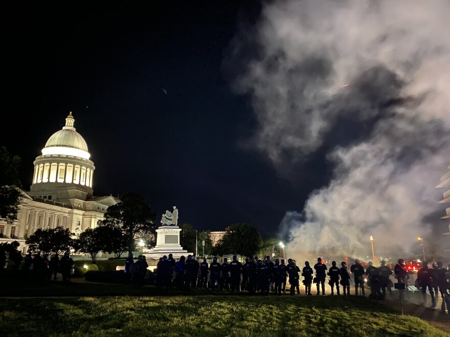 Police in full riot gear at the Arkansas State Capitol on Saturday night use a chemical agent to force protesters to disperse. A similar scene took place again on Sunday night.