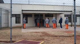 Inmates are seen lining up to receive their medication at Joseph Harp Correctional Center in Lexington.