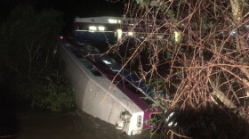 In this image provided the Alameda County Fire Department, first responders work the scene after a car of a commuter train plunged into Alameda Creek after the train derailed about 45 miles east of San Francisco. Crews had to fight the creek's fast-moving currents to pull passengers from the rail car.
