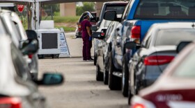 People line up for drive-thru COVID-19 testing in Austin.