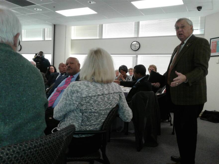 Union County Rep. Craig Horn (standing) talks to CMS officials at legislative breakfast about his efforts to tweak the reduced classroom size legislation for K-3.