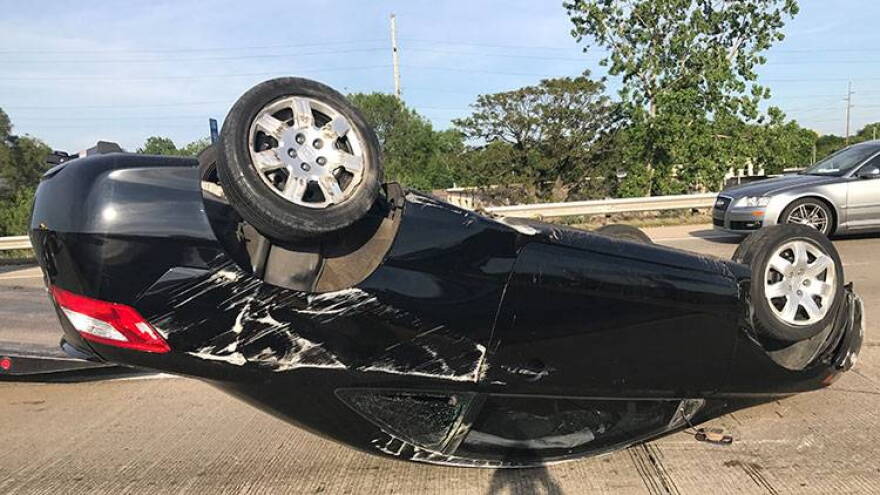 Indianapolis Police Chief Bryan Roach and two concerned citizens helped the driver of this car to safety. The driver's injuries were not expected to be serious..