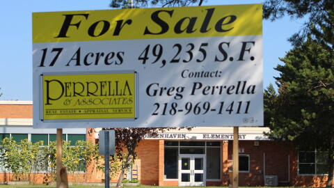 A "For Sale" sign is posted outside Greenhaven Elementary on Aug. 27, 2026, in Hibbing. The school closed in June.