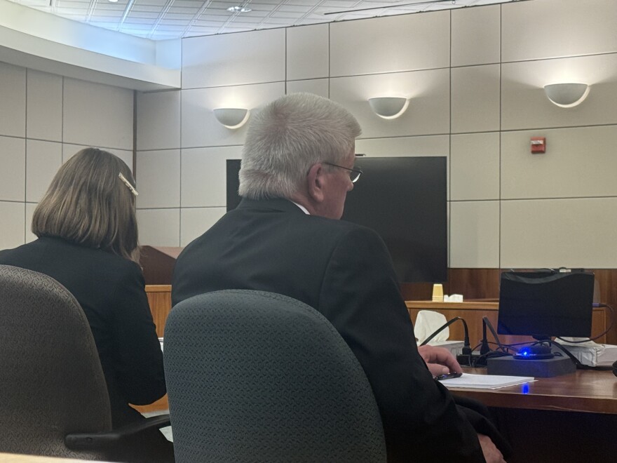 Michael Paschall, 63, at right, sits next to his attorney, public defender Hannah Marx, during his sentencing hearing July 9, 2026, in Fairbanks, Alaska. Paschall pleaded guilty in January to one count of felony scheme to defraud for stealing money from the Rural Deltana Volunteer Fire Department while he was serving as chief.