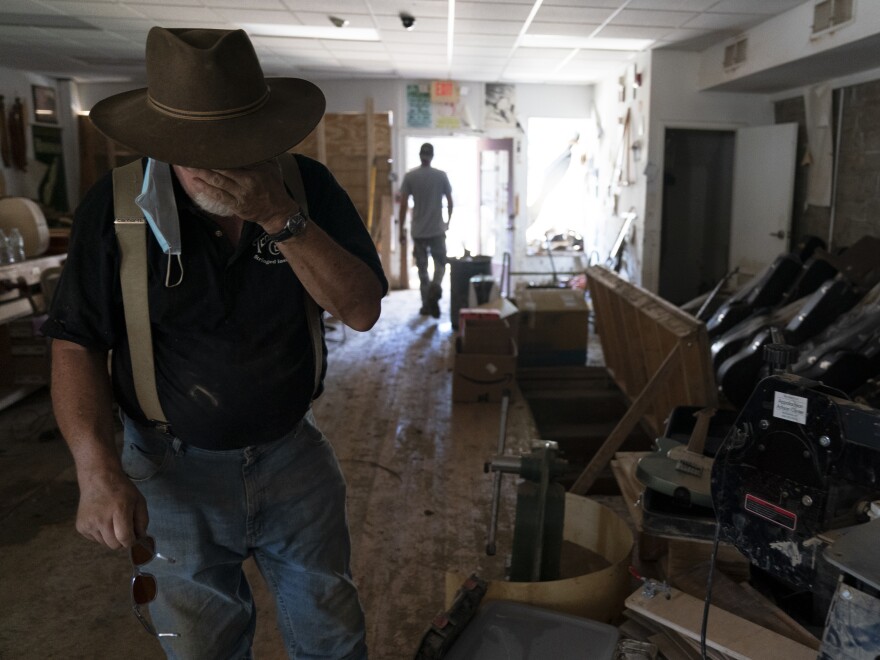 Doug Naselroad inspects recent flood damage at the Appalachian School of Luthiery in Hindman on Wednesday.