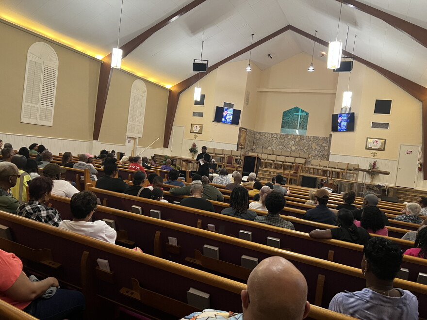 People gather in Greater Peace Missionary Baptist Church for a town hall meeting