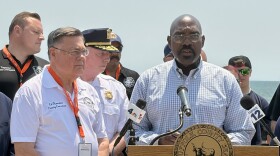 Suffolk County Health Commissioner Dr. Gregson Piggot (right) offers tips to stay safe during the heat wave at a news conference at Smith Point Beach in Shirley, NY, on June 30, 2026.
