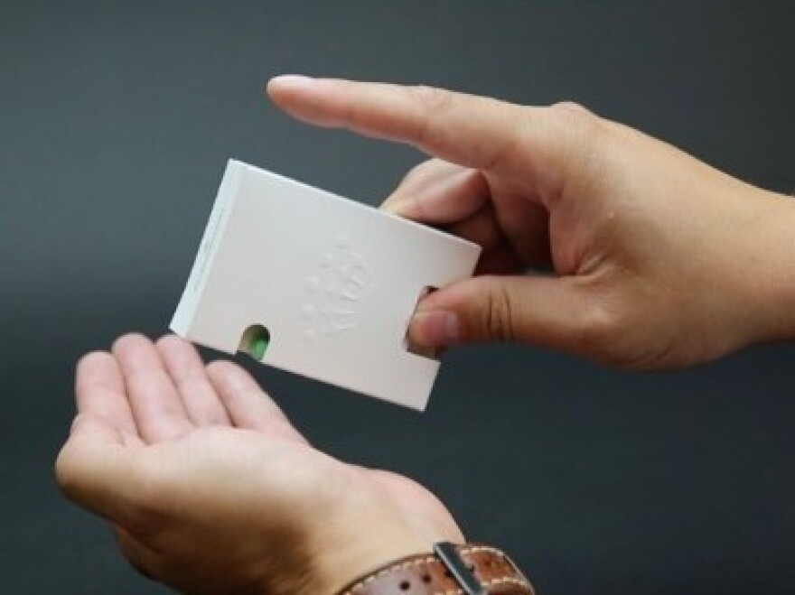 BillerudKorsnäs has designed their own version of a Tic Tac box, with a paper spring-loaded door that releases candy.