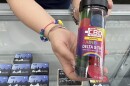 A woman holds a package of rainbow-colored Delta-9 THC gummies for sale