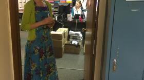 Arena White, a teacher at Kachemak Selo School, pauses in the doorway at the school's office (Photo by Daysha Eaton, KBBI - Homer)