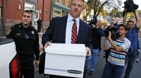 Mike McQueary leaves the Centre County Courthouse Annex in Bellefonte, Pa., Monday, Oct. 17, 2016 surrounded by reporters.