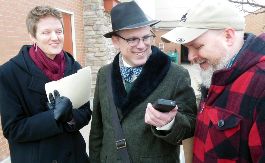 Bethany Rozeboom, Art Bristol and Corey Ledon (left to right) do a phone interview with the Associated Press after the Secretary of State's office rejects their paperwork for a new driver's license.